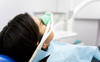 Patient breathing in nitrous oxide in treatment chair